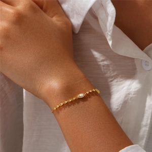Close-up of gold S925 silver evil eye bracelet with marquise-cut diamond on wrist