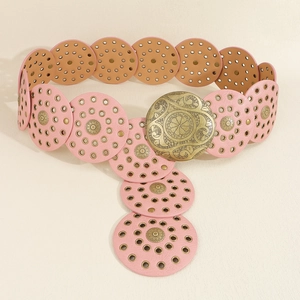 Detailed close-up of pink leather belt with hollow circles, metal studs and gold buckle