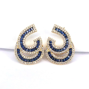 Detailed close-up of gold stud earrings with blue and clear pavé zircon stones