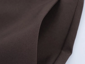 Macro shot of dark brown high-density fabric texture for blazer and pants set