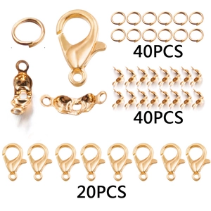 Golden DIY jewelry kit detail featuring lobster clasps, jump rings and crimp beads
