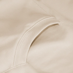 Close-up of beige knitted hoodie fabric showing ribbed cuff and stitching detail