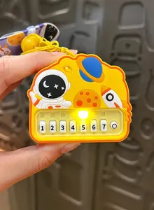Detail view of a yellow astronaut mini rhythm piano keychain with functional glowing light effect