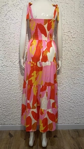 Detailed back view of a floral maxi dress featuring tie straps and smocked bodice details