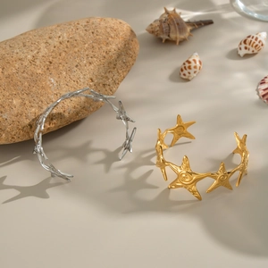 Starfish open cuff bracelet in gold and silver finish with seashell decor