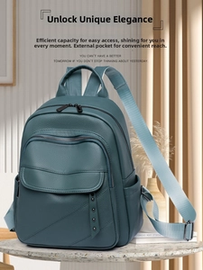 Detail view of deep blue pebble grain leather backpack showing rivet details and side pocket