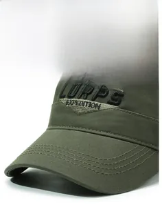 Close-up of military green camo cap featuring 3D embroidered CORPS EXPEDITION text