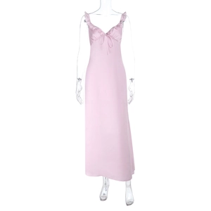 Detail of pink satin slip dress featuring deep V-neckline and delicate bow decoration