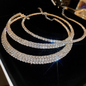Close-up of three layered silver rhinestone chokers with elegant sparkling starburst effect