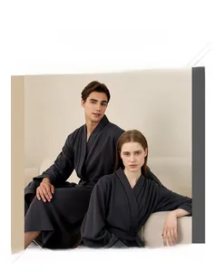 Close-up of dark grey waffle weave cotton bathrobes for couples showing texture and belt