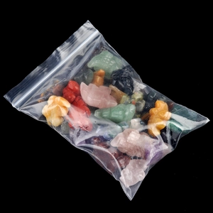 Miniature amethyst and agate crocodile animal carvings in a clear protective bag