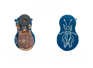 Macro view of blue PCB circuit board with buzzer and CR2032 battery for cricket noise maker