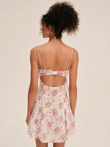 Detail of floral mini dress featuring triple spaghetti straps and a back cutout with bow