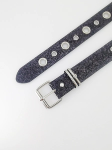 Detailed view of dark gray glitter leather belt with silver metal buckle and metal eyelets