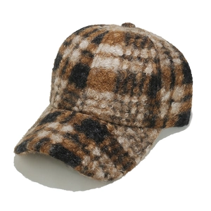 Detail view of brown plaid baseball cap with warm sherpa wool texture and classic check pattern