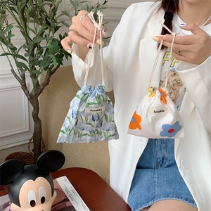 Floral cotton drawstring bags in Japanese style held by hand for cosmetic storage