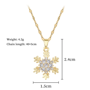 Detail showing dimensions of spinning snowflake pendant necklace in gold plated titanium steel
