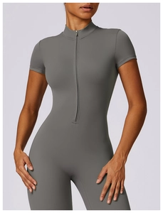 Detailed close-up of dark grey yoga bodysuit featuring high-collar and half-zipper design