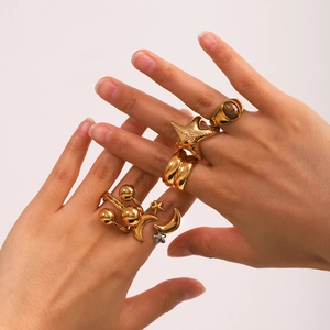 Two-tone stainless steel star and moon rings set with tiger eye stone on model hand