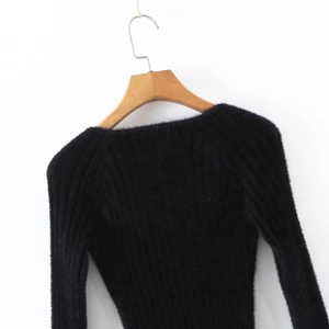 Detail of black V-neck ribbed knit sweater showing soft mohair texture and vertical stripes