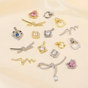 Artistic arrangement of gold and silver plated heart pendants with colorful zircon stones