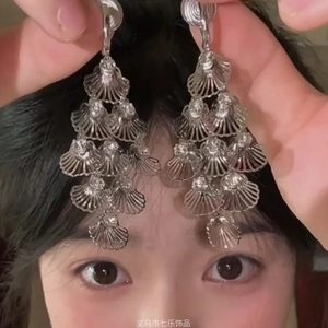 Bohemian style silver tiered shell fringe drop earrings featuring textured shell layers
