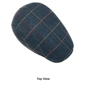 Top view of a classic British style herringbone tweed flat cap in navy with red accents