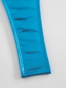 Macro detail of metallic blue one-piece swimsuit fabric with double-stitched hem edges