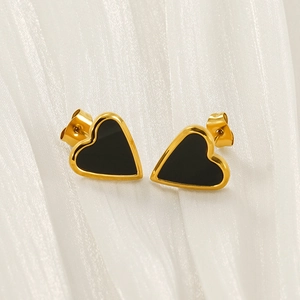 Elegant gold-tone heart studs with black enamel on premium white silk background