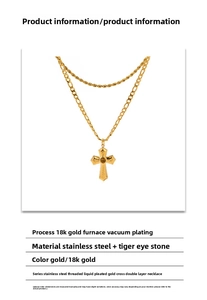 Detailed view of gold double layer necklace with cross pendant and tiger eye stone inlay