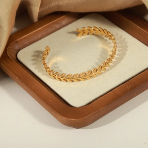 Golden wheat-shaped open cuff bracelet in titanium steel with leaf textures on silk