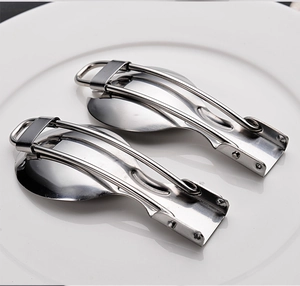 Macro detail of foldable stainless steel spoons placed on a white ceramic plate