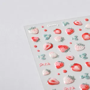 Macro view of 5D embossed strawberry nail art stickers with realistic Berry textures