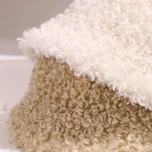 Plush lamb wool bucket hats in beige and khaki showing soft curly faux fur texture