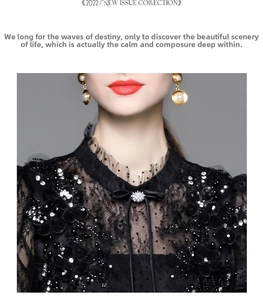 Detail of high neck lace dress with beaded sequins and intricate floral embroidery