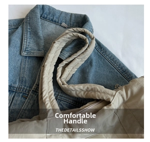 Close-up of padded nylon tote handle with soft texture and durable stitching detail