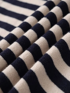 Macro shot of striped knit fabric showing texture and soft layered pleats on this top