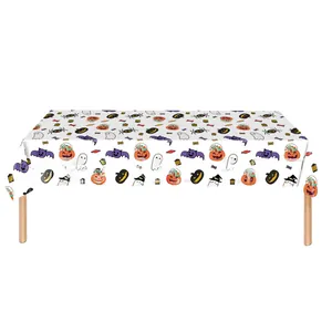 Detailed close-up of a white Halloween tablecloth with cartoon pumpkin and ghost patterns