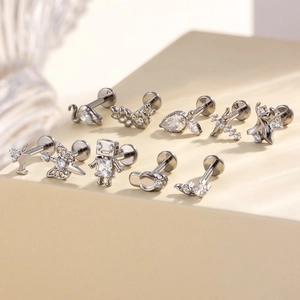 Titanium labret studs with zircon inlays featuring swan, star, and cross shapes