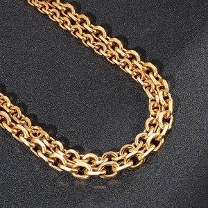 Close-up of double-layered gold stainless steel O-chain with flat links on black background