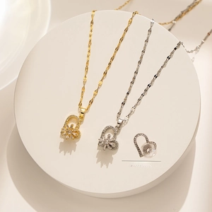 Detail showing 360-degree rotating heart pendant necklaces in gold and silver colors