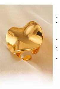 Detail of 18K gold-plated irregular wave heart-shaped open ring on silk fabric