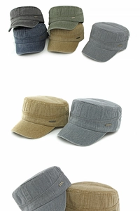 Macro detail of washed cotton fabric and metal brand logo on military flat top caps