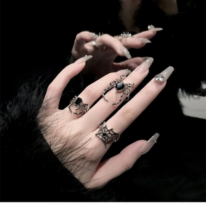 Gothic spider ring set with black gemstone and cobweb details on silver alloy metal