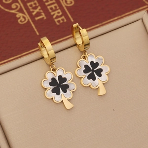 Elegant gold double-layer necklace with clover pendants on a beige jewelry display box