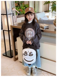Toddler modeling a lightweight panda cartoon backpack in a cozy home setting
