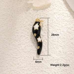 Detail view of a 26mm black enamel pepper charm with gold stars and metal hardware