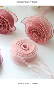Macro shot of gradient organza fishtail ribbon showing delicate textures and soft colors