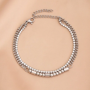 Macro detail of silver double-layer bracelet with horse hoof chain and white zircon inlay