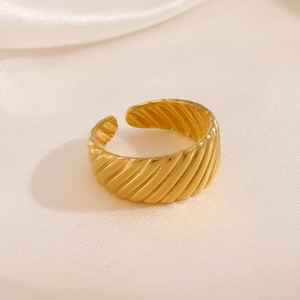 Polished gold croissant dome ring on silk background with adjustable open design
